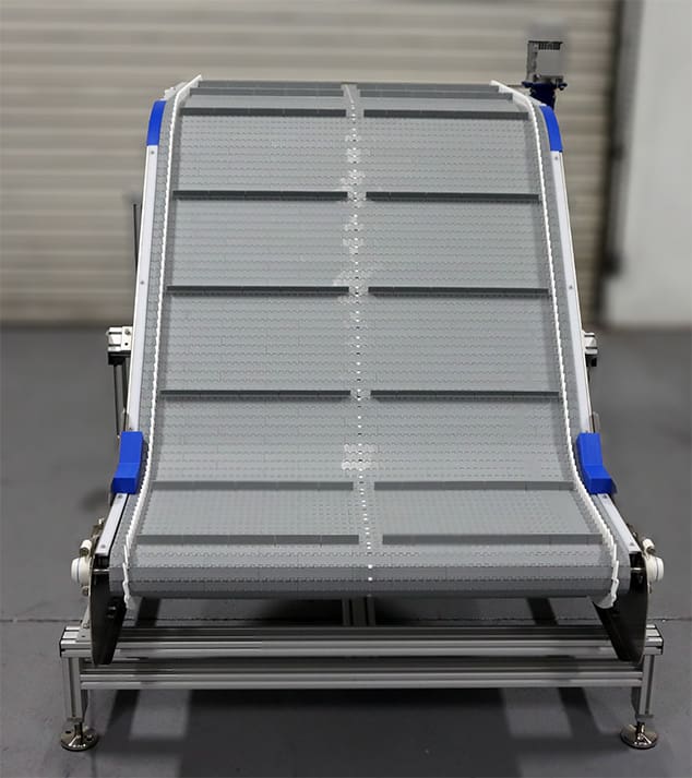 Z-Belt Conveyor System moves automotive parts to higher elevation.